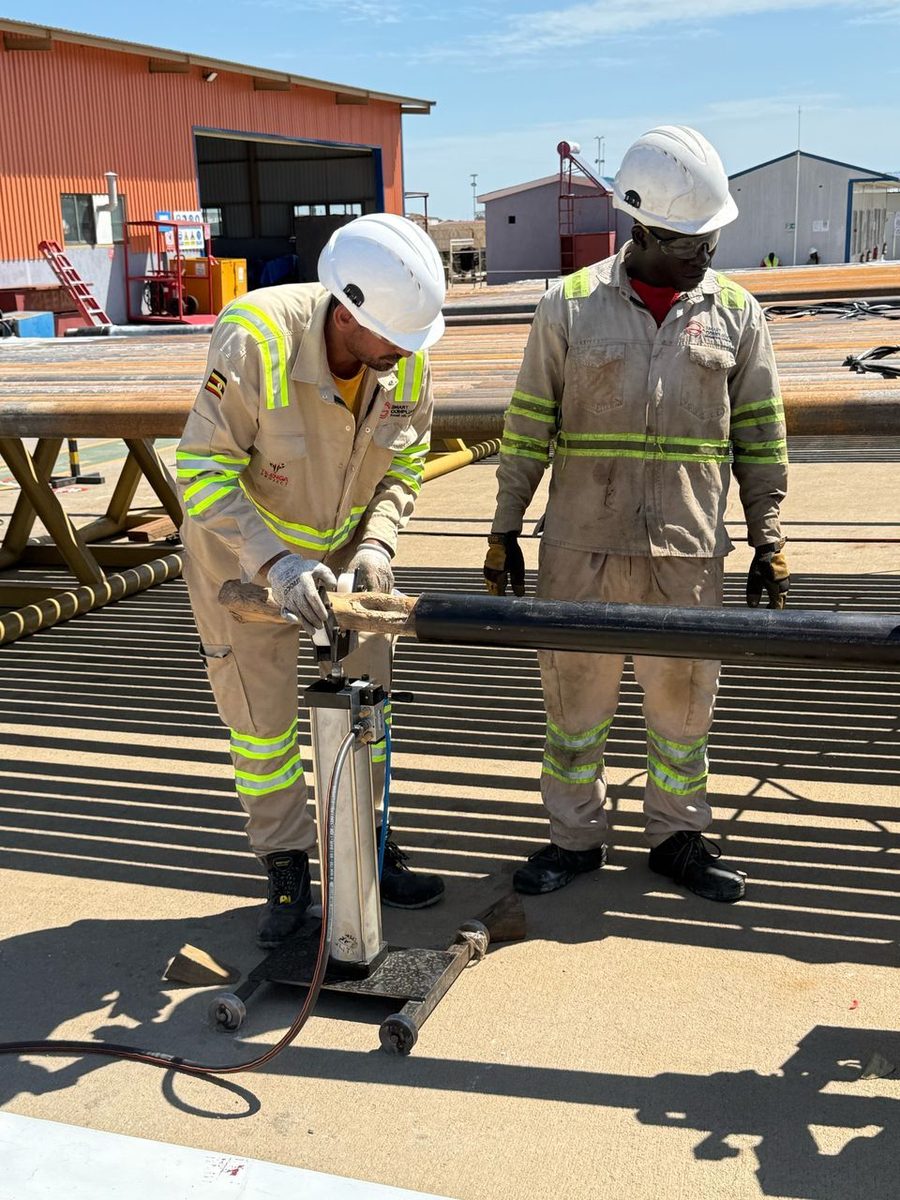 SCL inspectors running the EMI inspection buggy along a drill pipe on the rack