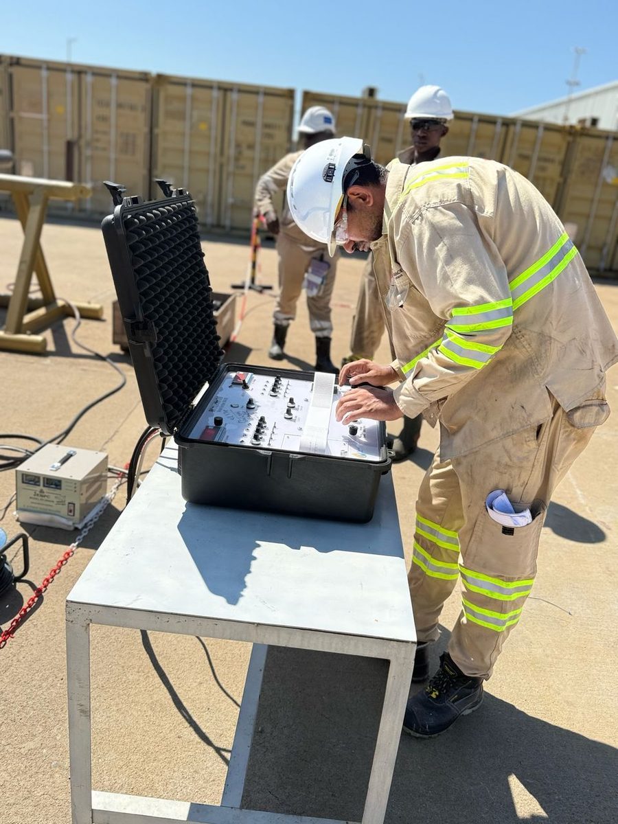 Inspector setting up the EMI control unit beside the pipe rack