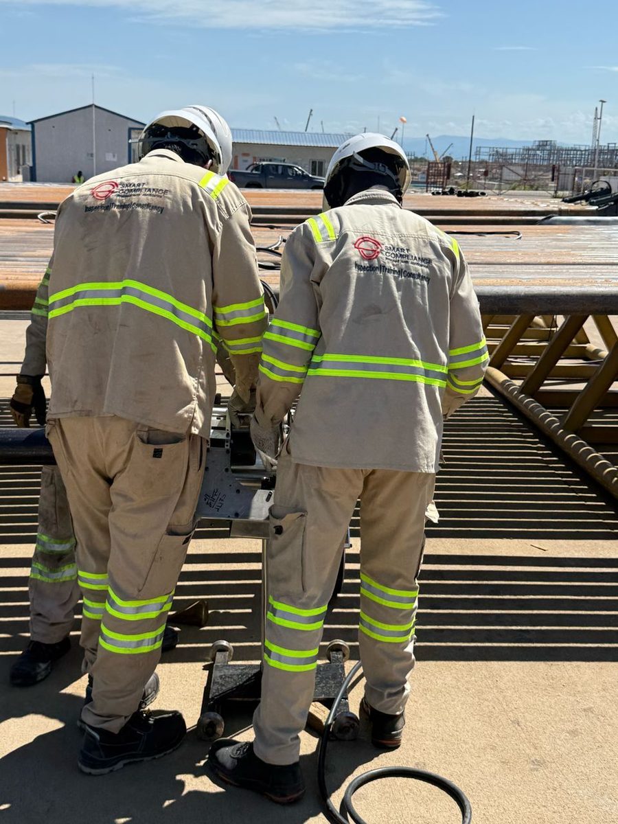 SCL EMI crew working on a rack of drill pipe