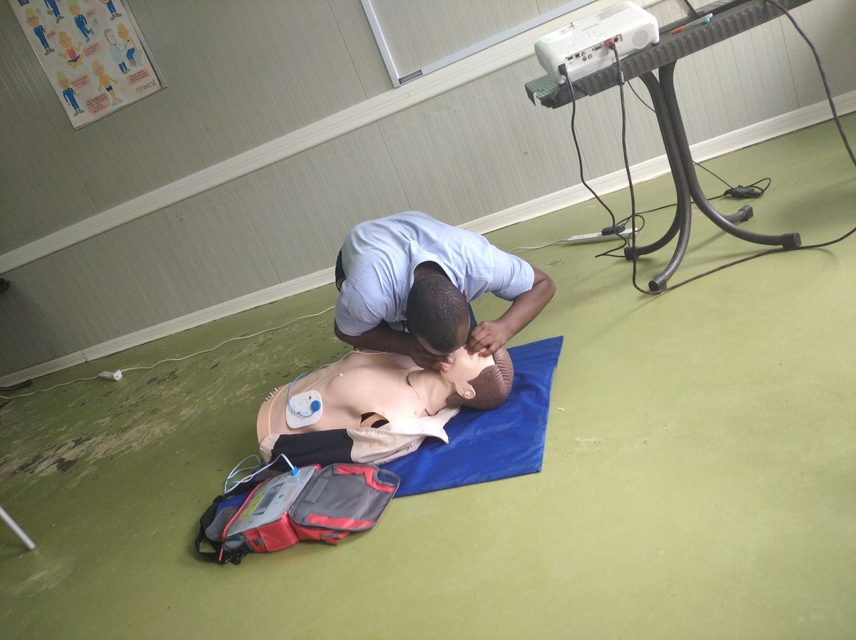 Learner practising CPR on a manikin during a first aid course