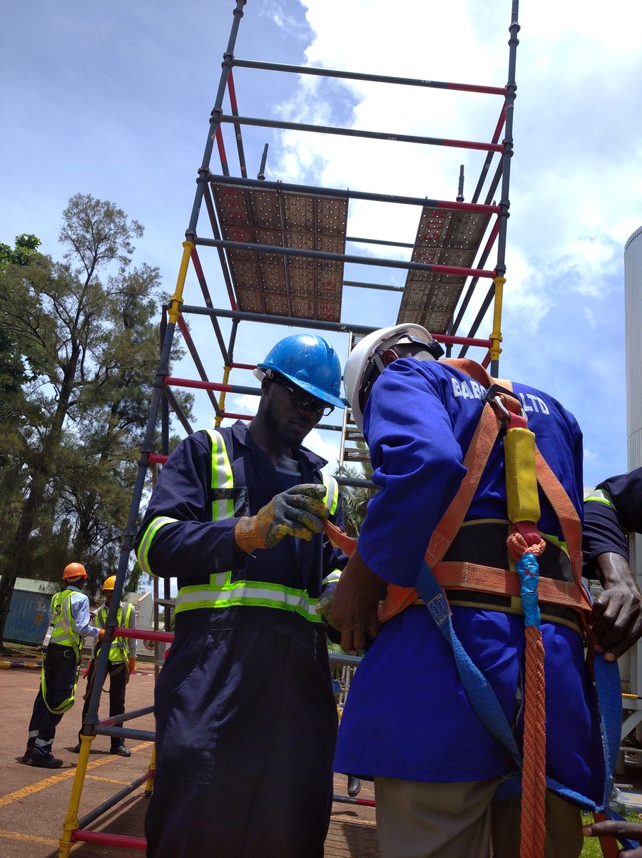 Learners checking a full body harness before working at height