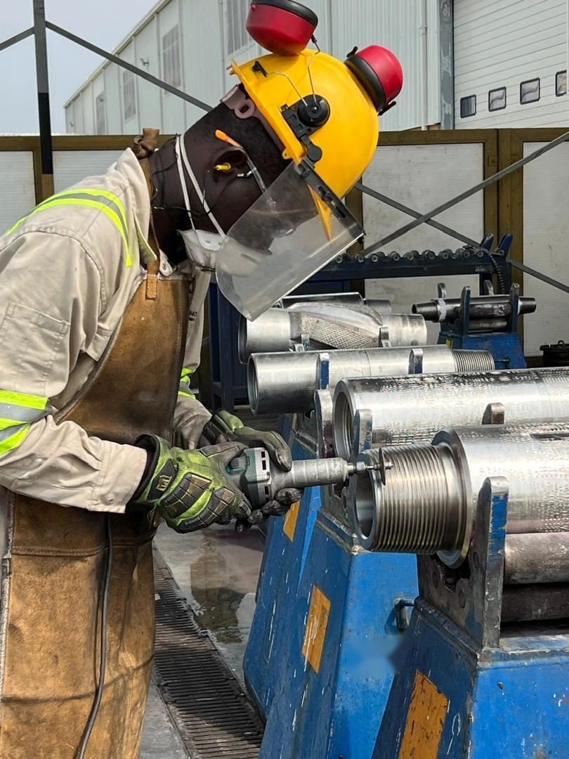SCL inspector examining a drill string connection thread in the workshop